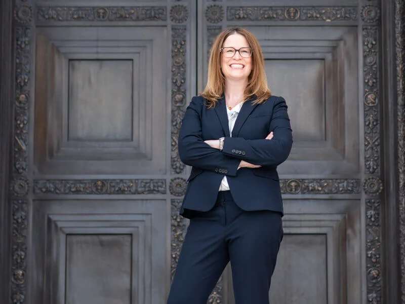 Attorney Lydia Floyd standing confidently in front of ornate doors