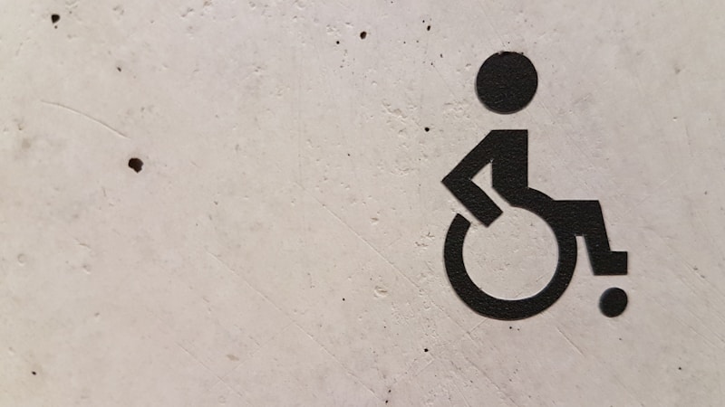 Wheelchair accessibility symbol on concrete wall