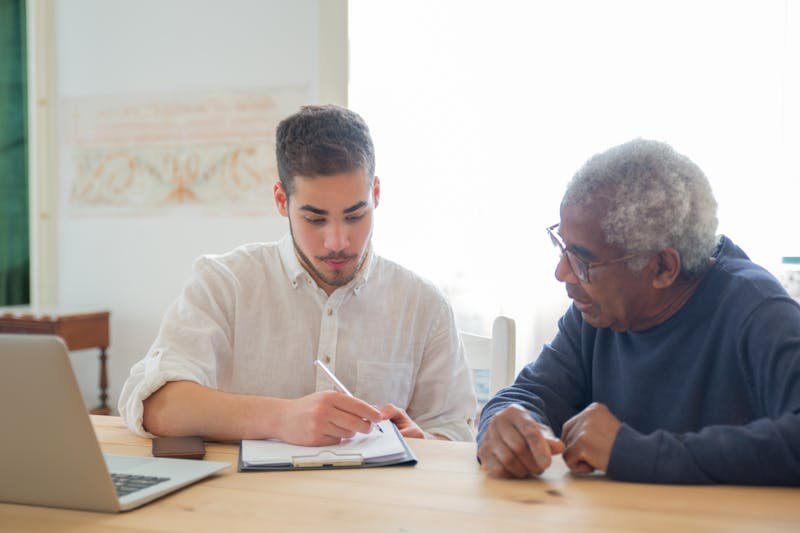 Younger and older professionals working together at a table