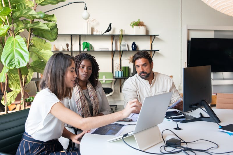 Professionals collaborating at a modern office desk